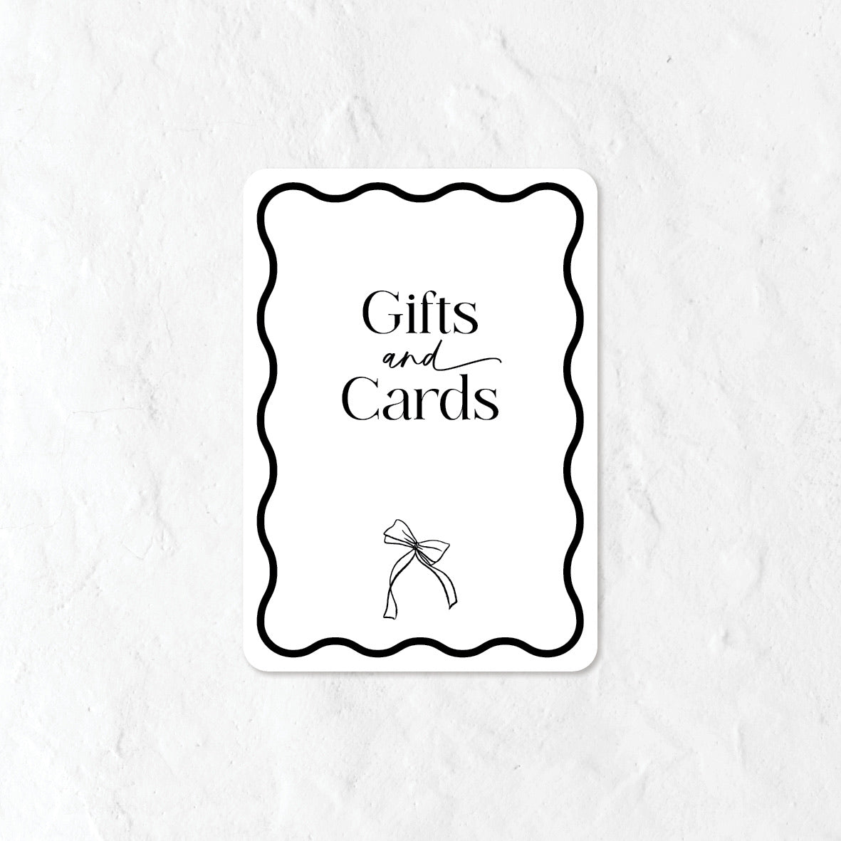 Black and white Gifts and Cards sign and a bow illustration