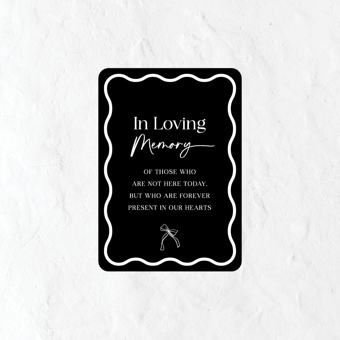 Black and white in loving memory sign with a bow icon
