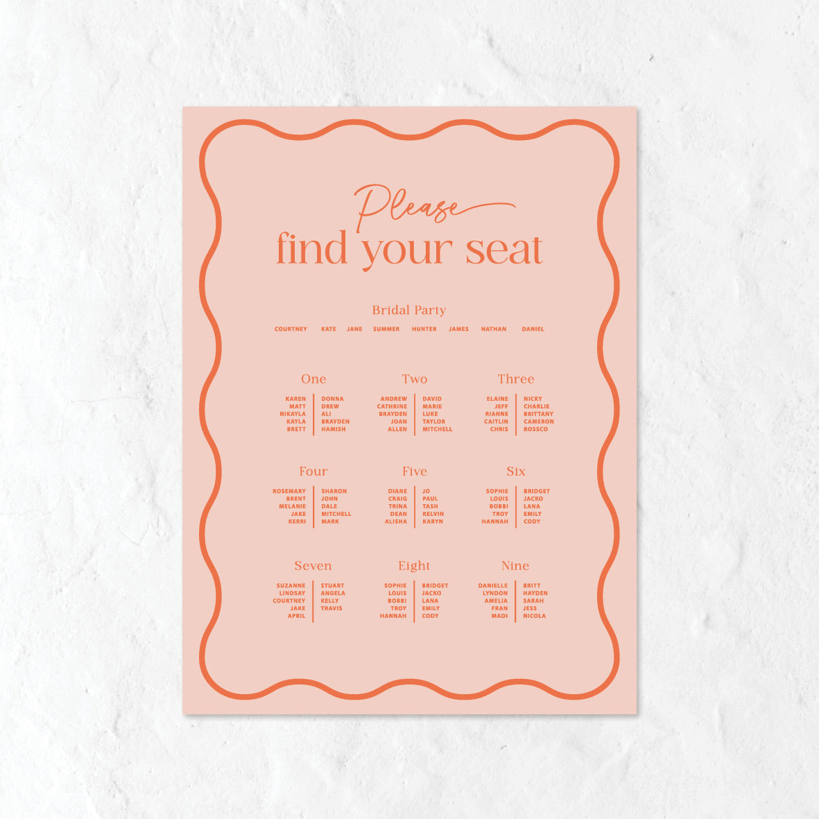 Pink seating chart for a wedding on a white textured background