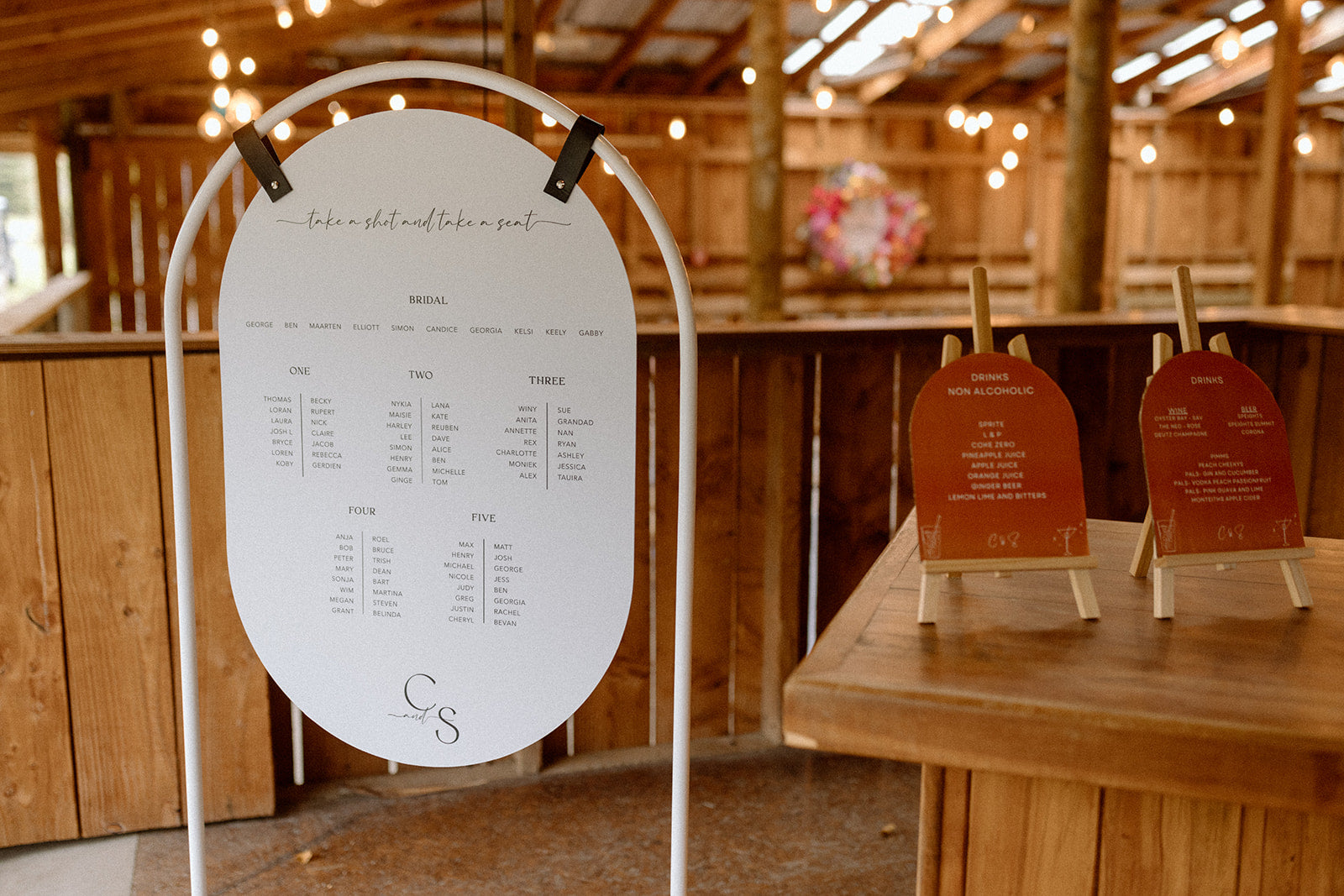 Custom white oval seating plan set in the rustic wedding venue Glendhu Station