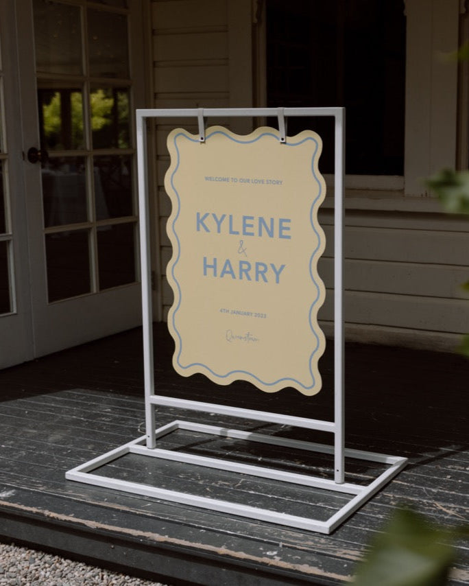 Pastel yellow and blue welcome sign at the Winehouse in Queenstown