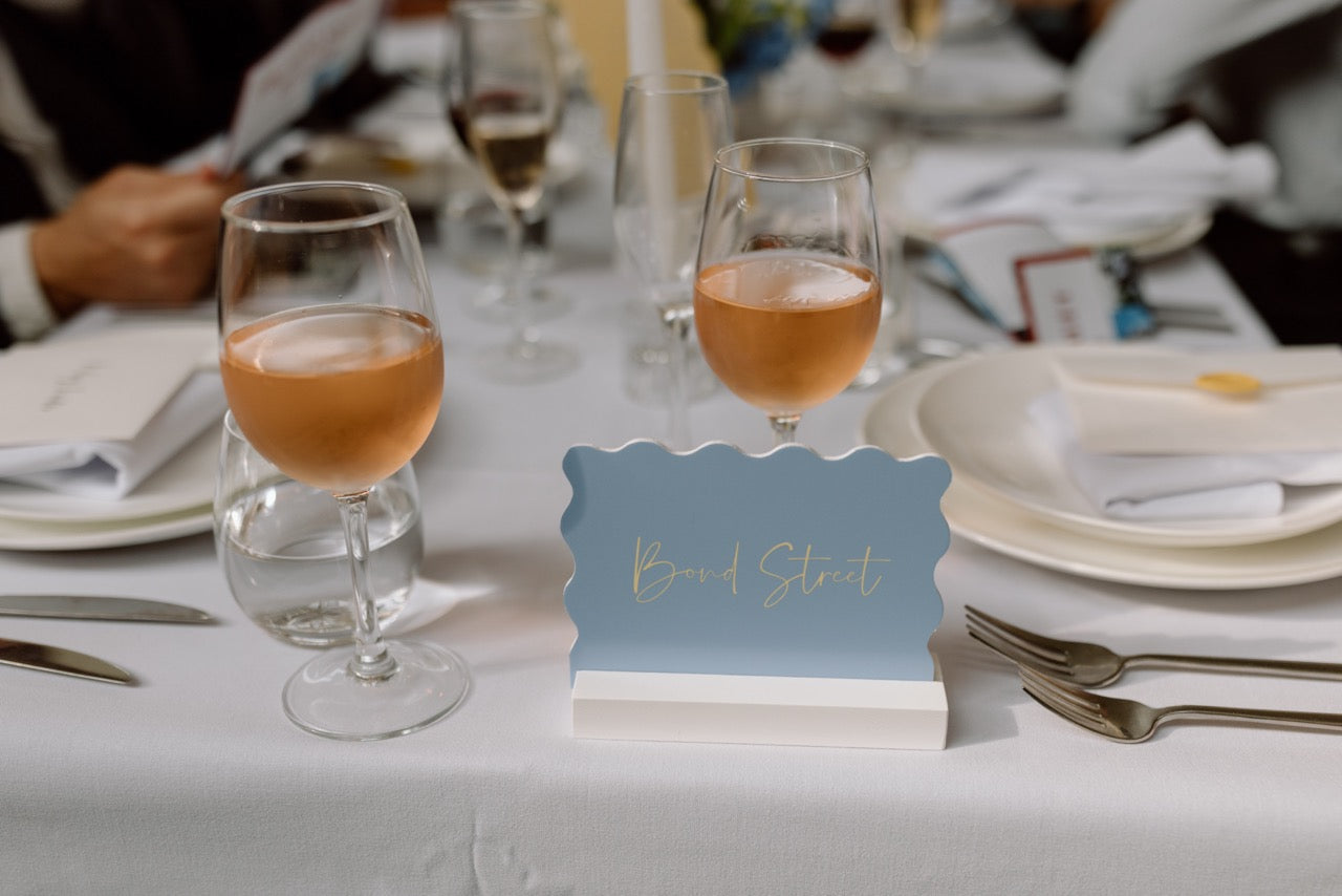 Wavy pastel blue table names for Kylene and Harry at the Winehouse in Queenstown