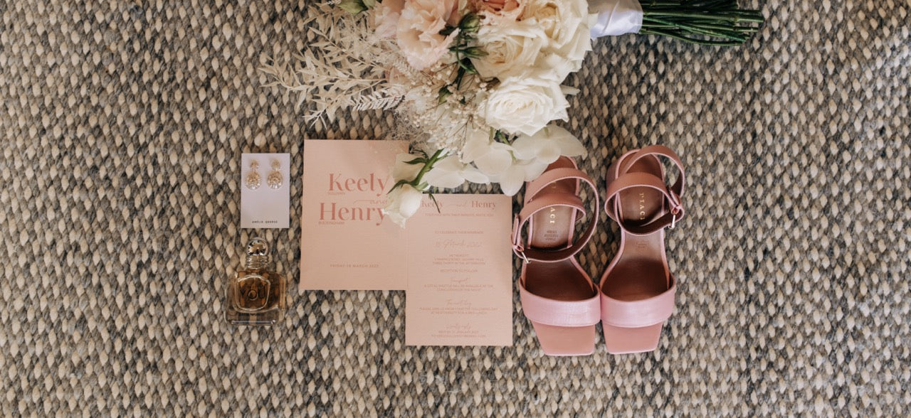 Rose gold sandals, bouquet pink invitation flat lay