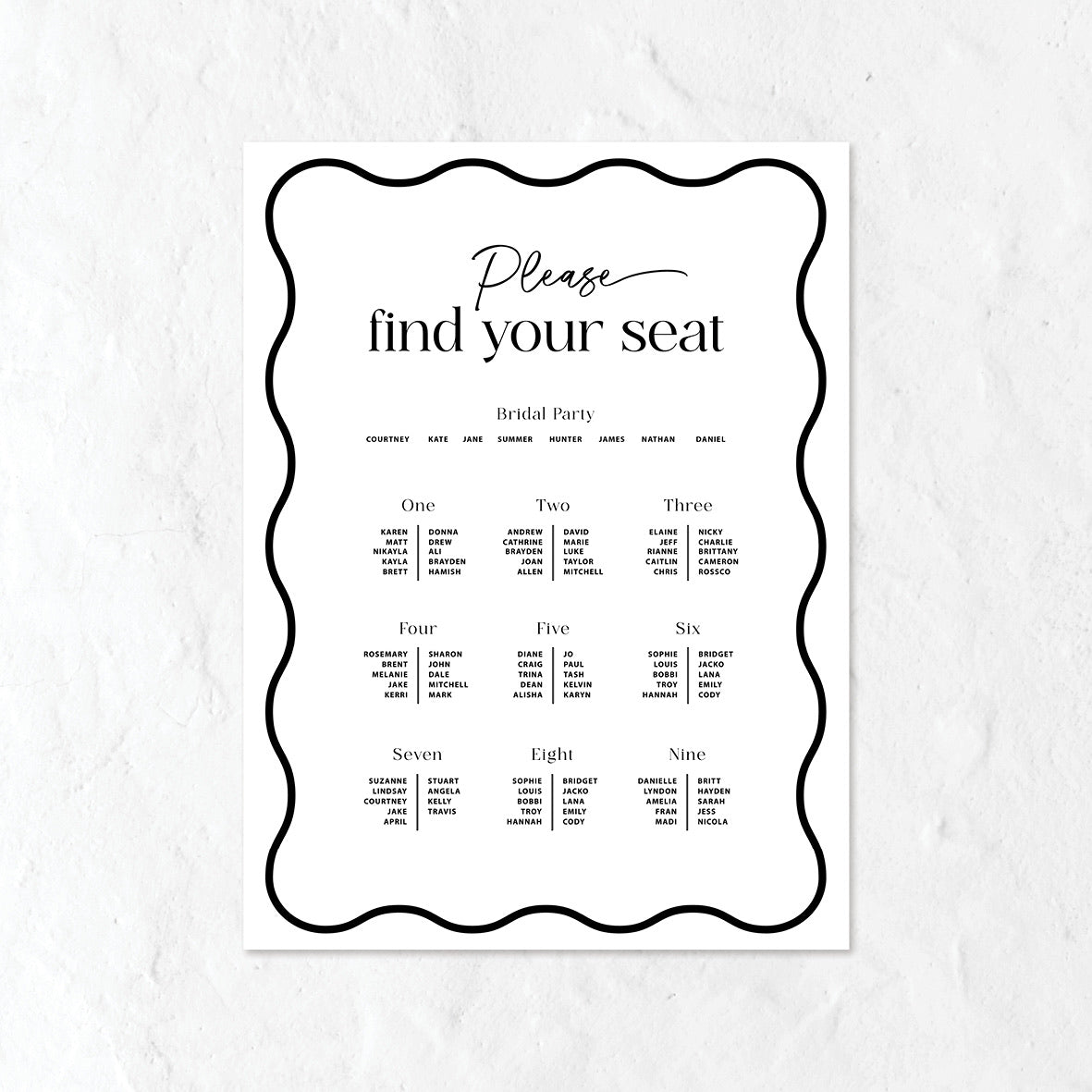 Black and white seating chart for a wedding on a textured white background