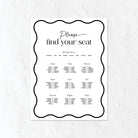 Black and white seating chart for a wedding on a textured white background