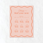 Pink seating chart for a wedding on a white textured background
