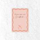 Please sign our Guestbook sign in a natural pink and orange colour palette 