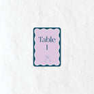 Table number sign in a pastel blue and purple palette