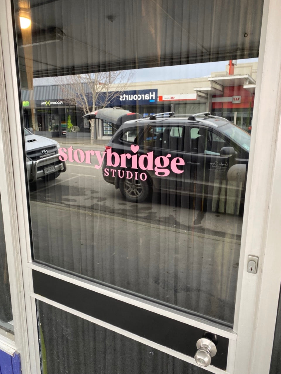 Storybridge Studio window lettering signage