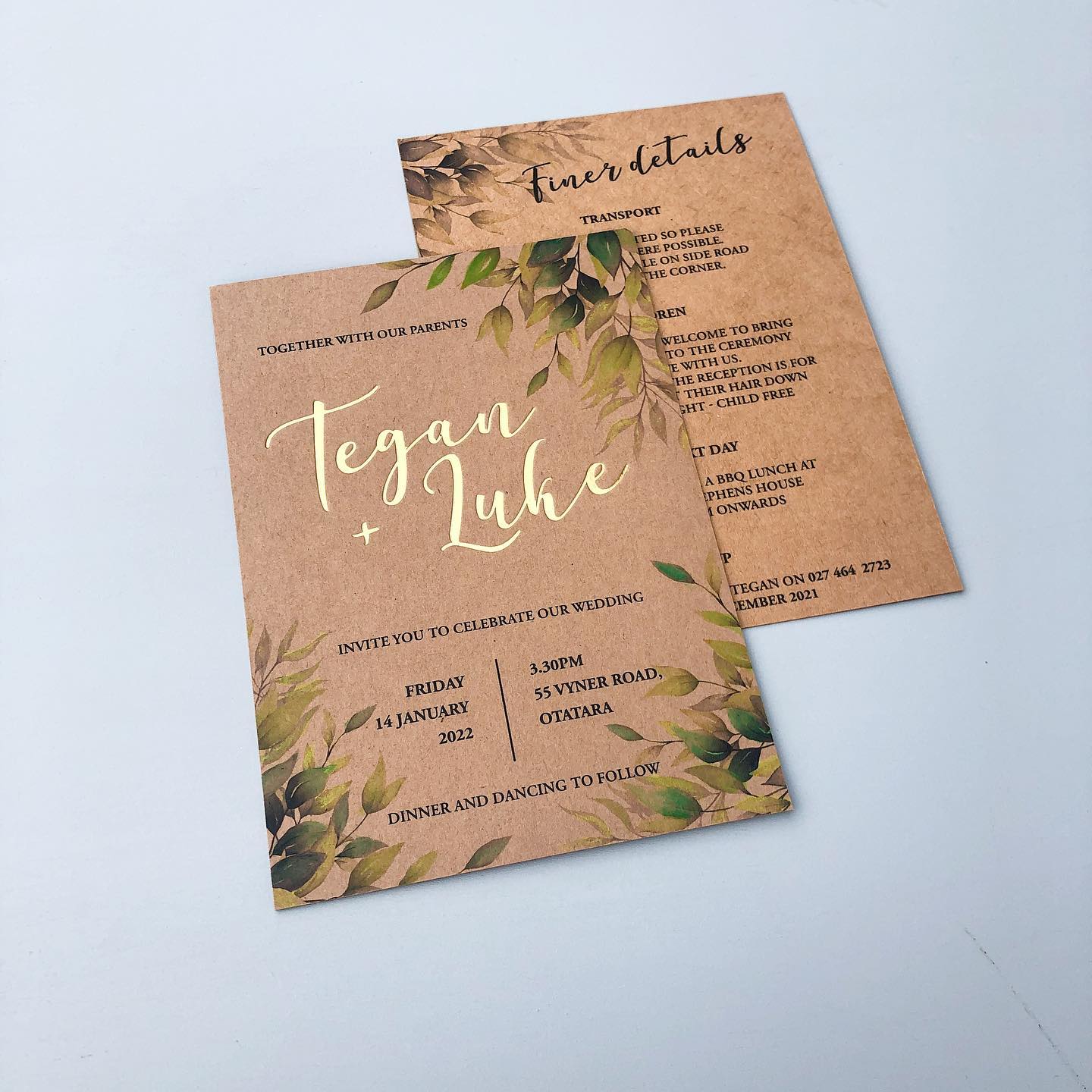Wedding invitations with green leaves printed on natural card with foil lettering