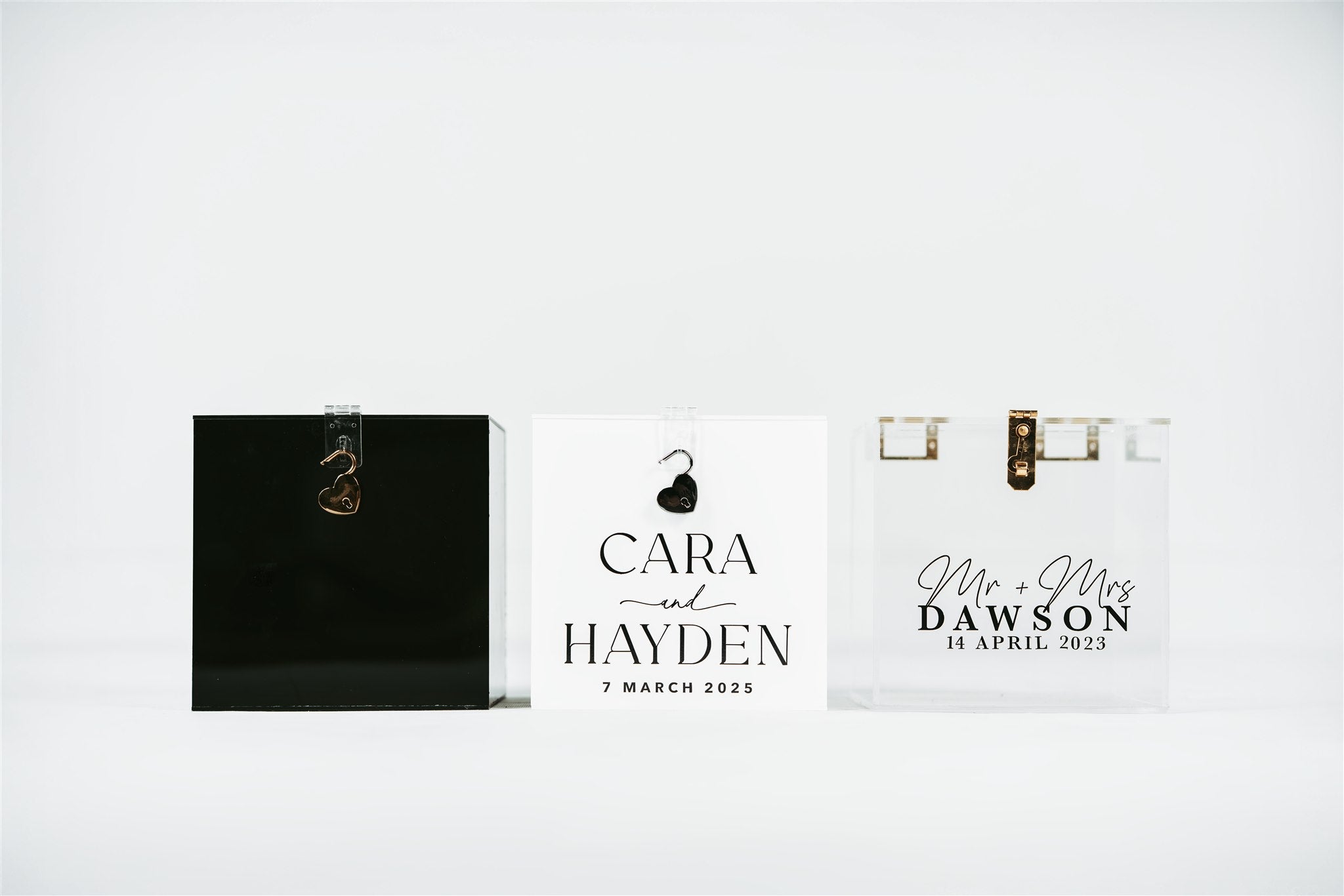 Personalized wedding gift boxes with names and dates on a white background